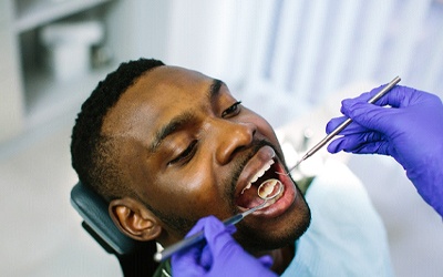a person receiving a dental checkup from their dentist