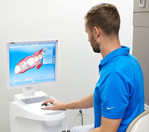 Dentist looking at intraoral images on computer screen
