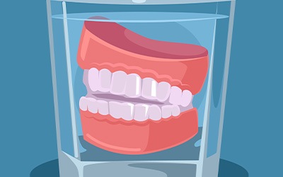 Dentures soaking in a glass of water
