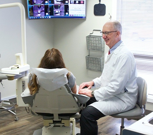 Dentist smiling at dental patient