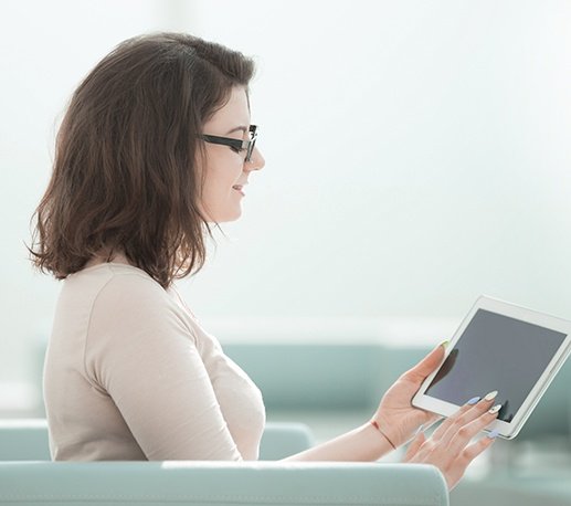 Dental patient looking at tablet computer