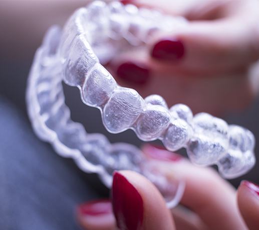 Hand holding a Clear Aligners tray