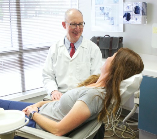 Doctor Campbell smiling at dental patient