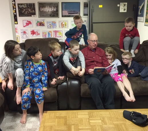 Doctor Campbell reading to grandchildren