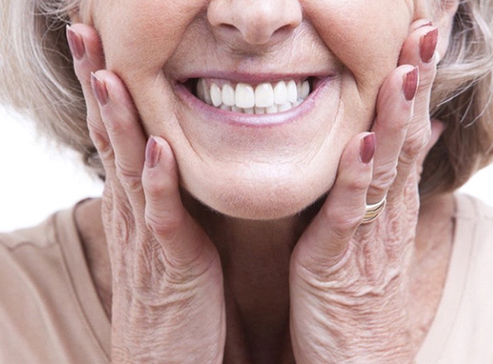 senior woman smiling with dentures in Granger