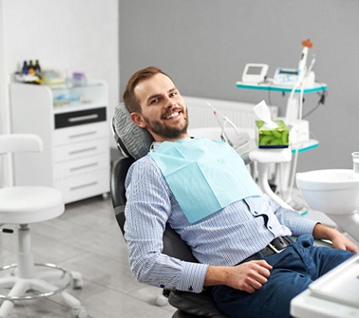 Dental patient smiling at appointment for dental implant surgery