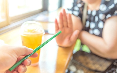 Woman saying no to drinking straw after oral surgery