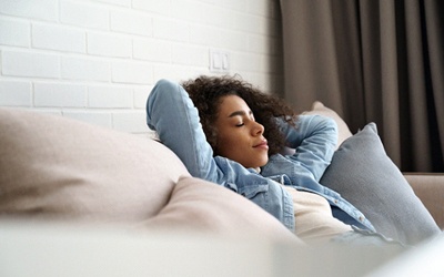 Woman relaxing at home after dental implant surgery