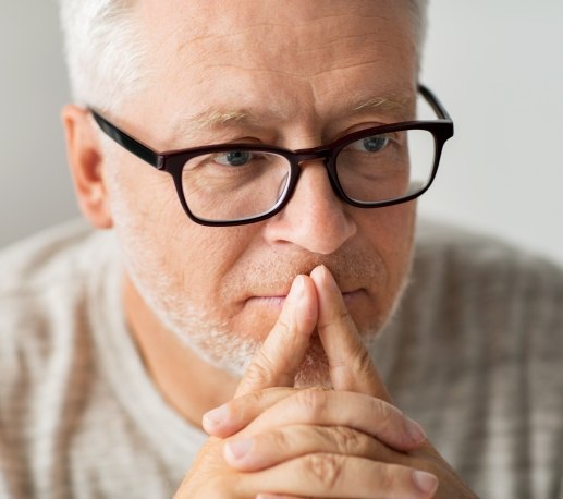 Older man considering dental implant tooth replacement