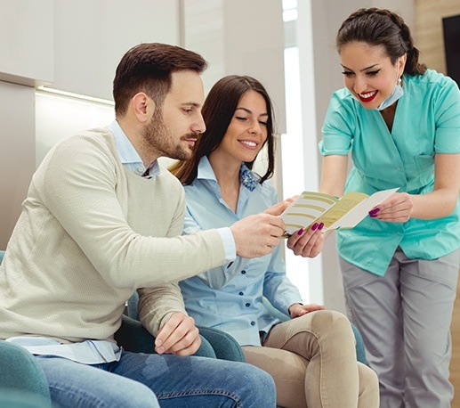 Man and woman reviewing dental insurance information