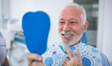Man looking at smile after restorative dentistry
