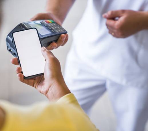 Patient using phone to pay for dental treatment