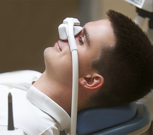 Dental patient with nitrous oxide sedation dentistry mask in place