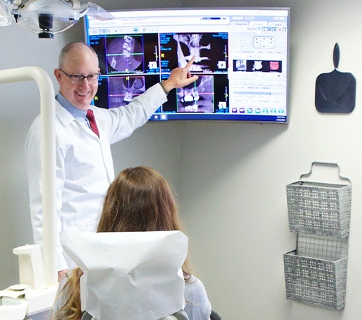 Doctor Campbell and dental patient looking at x-rays